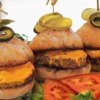Kobe Sliders · Three juicy burgers topped with American cheese, served on tuscan mini-buns.