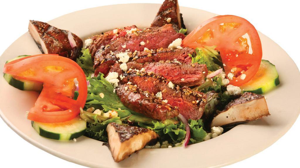 Sirloin Bleu Cheese · Spring green blend, sliced tomato, cucumber, and red onion topped with slices of charbroiled medium angus sirloin, grilled portabella mushrooms, and bleu cheese crumbles. Served with cut green blend and dressings.