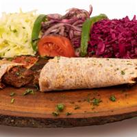 Wrapmacun · Adana or urfa kebab wrapped in lahmacun. Served with a side of lettuce, red cabbage, chopped...