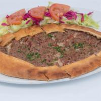 Ground Meat Pide · Thick dough stuffed with seasoned ground meat, baked in a brick oven. Served with a side sal...