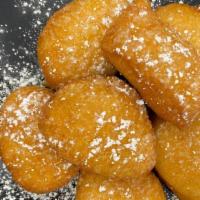 Honey Biscuits (1/2 Dozen) · freshly fried biscuits with honey drizzled on top and a splash of powdered sugar