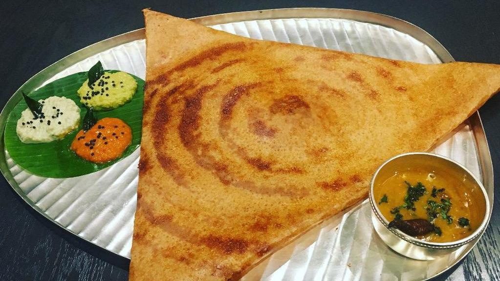 Onion Masala Dosa · Thin rice and lentil crepe filled with potatoes and onion. Served with three varieties of chutneys and sambar.