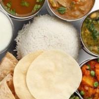 South Indian Thali · Rice, one chapati, sambar, rasam, kurma, koottu, poriyal, special kuzhambu, curd, special ra...