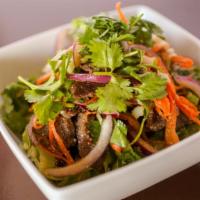Crying Tiger · Mixed-sliced beef, onion, scallions, carrots, dried
pepper and grounded rice with lime dress...