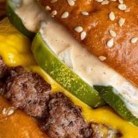 Classic Smash Burger · Seared and smashed beef patty, American cheese, chopped white onion, house pickles, Chomp sa...