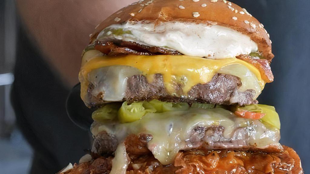 The Stack · From Bottom to Top, Lettuce, Tomato, Melted Onion, BBQ hot honey Fried Chicken, Beef Patty, Pepperjack Cheese, Jalapenos, Beef Patty, American and Swiss Cheese, Bacon, Pickles, and Chomp Sauce