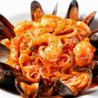 Seafood Fettuccine · Tender calamari, shrimp and mussels sautéed with fresh garlic and tossed in fettuccine with ...
