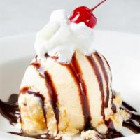Kids Sundae · One scoop of vanilla ice cream with drizzled chocolate sauce, whipped cream and a cherry on ...