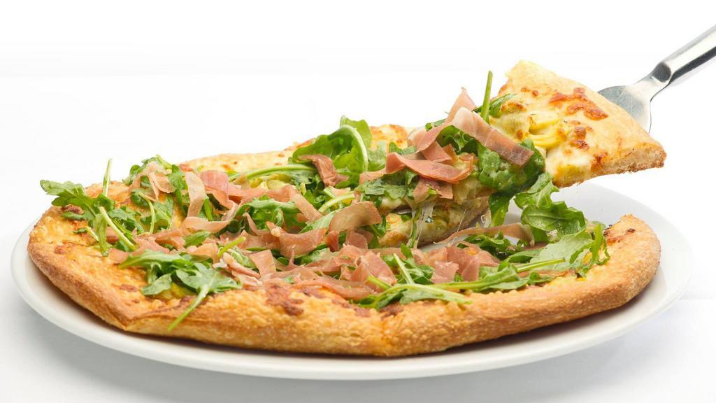 Prosciutto Pizza · House-made pizza crust with a mascarpone and roasted garlic base baked with artichoke and mozzarella, garnished with sliced prosciutto and arugula tossed in a basil vinaigrette.