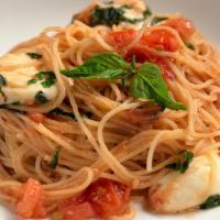 Capellini Pomodoro · Cappellini noodles tossed with white wine, garlic fresh tomatoes, fresh mozzarella and basil.