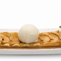 Warm Apple Torte · Sliced granny smith apples baked on a house-made pie pastry, served on a bed of hot caramel ...