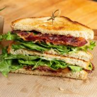 The Mile High Blt · Beef bacon, leaf lettuce, and tomatoes on sourdough bread, goodness to the last bacon crumb!