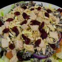 Minnesota Wild Rice Salad · Minnesota wild rice with turkey and roasted almonds served on a bed of greens with olives, t...