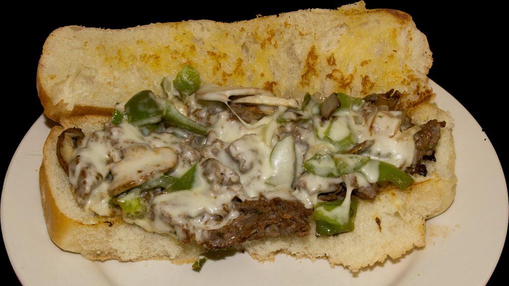 Philly Cheese Steak · Thinly sliced beef sirloin steak grilled with onions, green peppers, and mushrooms, topped with melted provolone on a grilled bun.