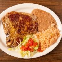 T-Bone Steak Especialidad · Grilled t-bone. Served with rice, refried beans, salad, and your choice of two tortillas.