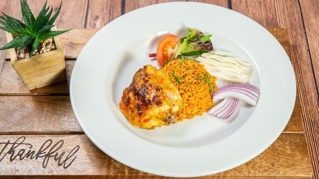 Chicken · Chicken wings seasoned and grilled with a flavorful spicy habanero pepper sauce served with jellof rice and salad.