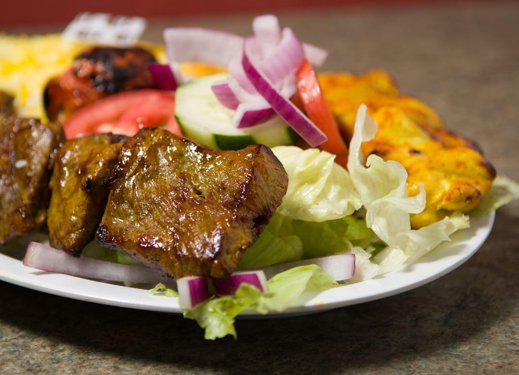 Chicken And Filet Combo · One skewer of our marinated boneless chicken breast and one skewer of our marinated chunks of beef tenderloin served with with a grilled tomato and choice of salad, rice or half salad and half rice.