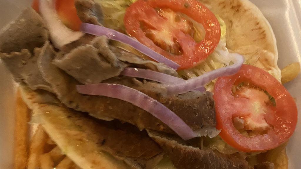 Gyro Wrap · Our famous hand carved beef and lamb gyro served in a pita bread wrap with lettuce, tomato and onions and a choice of French fries or a side salad.