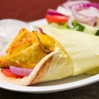 Chicken Wrap · Marinated boneless chicken breast served in a pita bread wrap with lettuce, tomato and onion...