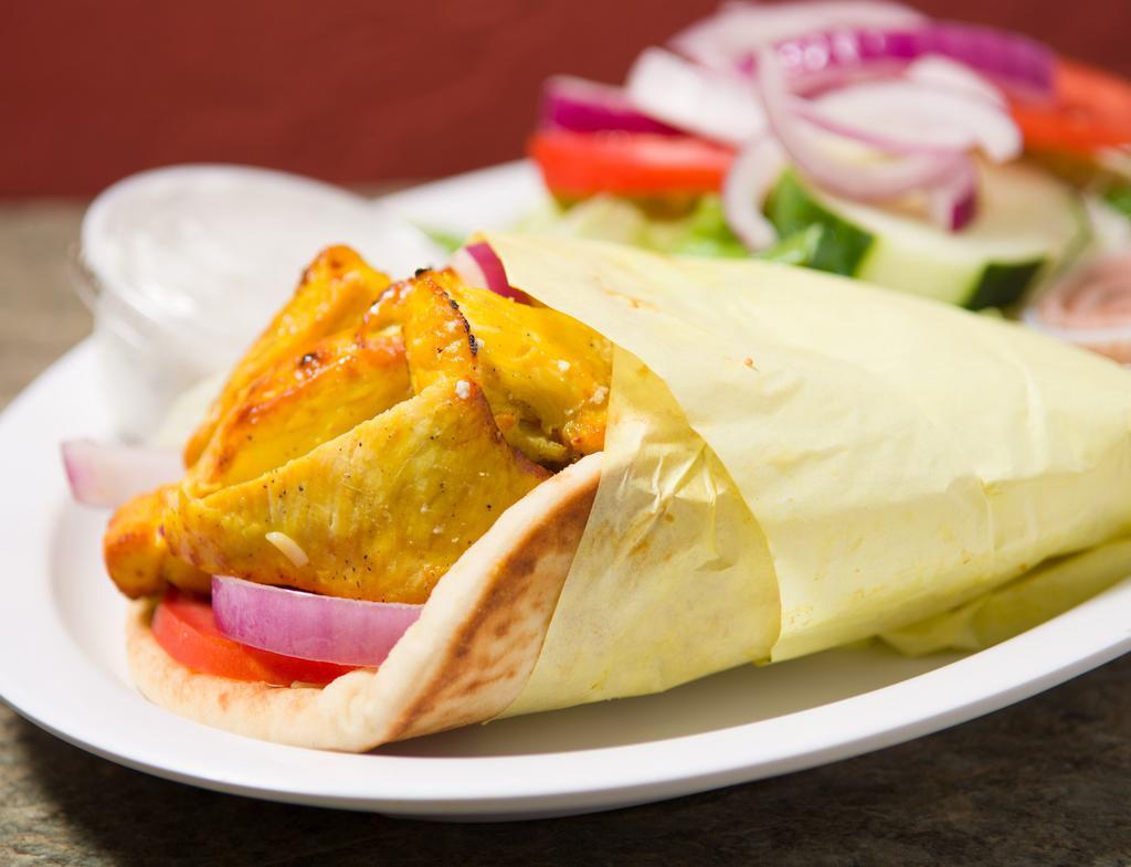 Chicken Wrap · Marinated boneless chicken breast served in a pita bread wrap with lettuce, tomato and onions and a choice of French fries or a side salad.