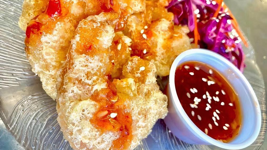 Dynamite Shrimp · 6 tempura shrimp tossed in a sweet and spicy chili sauce with cabbage slaw.