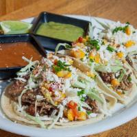 Smoked Taco Trio - Delivery · brisket | pulled pork | smoked chicken taco served with corn relish | cabbage | cotija chees...