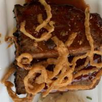 Bourbon Meatloaf · slabs of house made meatloaf made with chorizo sausage topped with a bourbon glaze & crispy ...