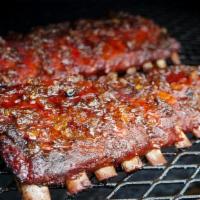 Ribs Half Rack · Dry rubbed slow roasted fall off the bone ribs with two sides