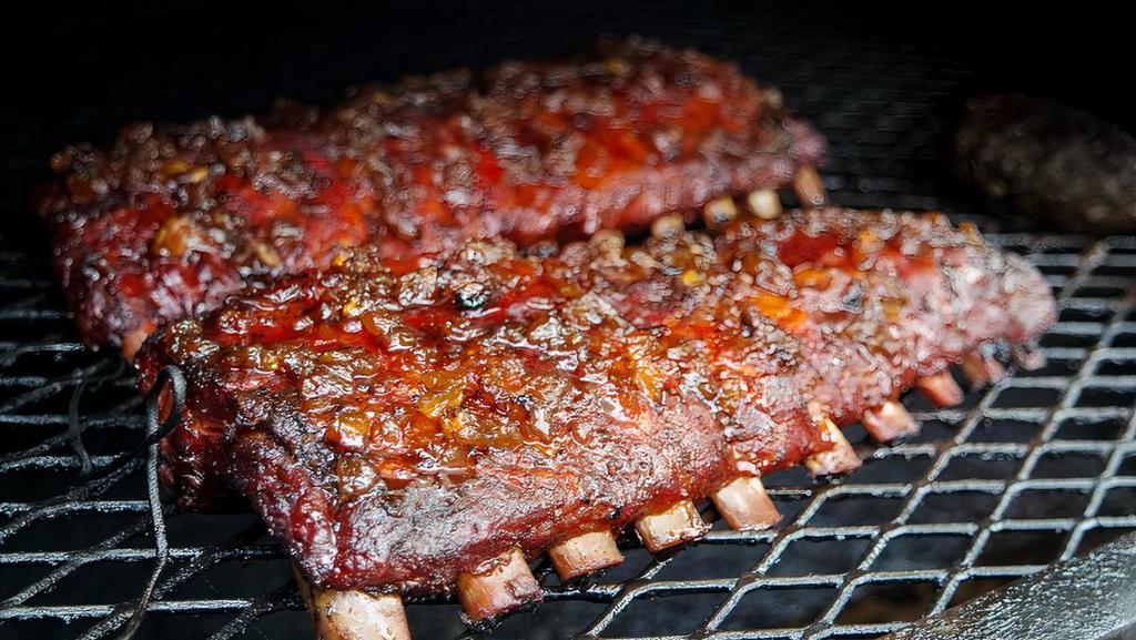 Ribs Half Rack · Dry rubbed slow roasted fall off the bone ribs with two sides