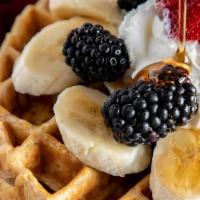 Waffles With Fruit · Belgian waffles served with various fruits and berries topped with syrup and whipped cream.