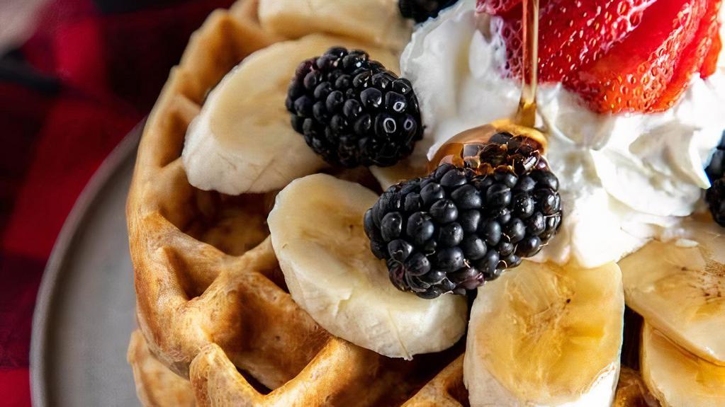 Waffles With Fruit · Belgian waffles served with various fruits and berries topped with syrup and whipped cream.