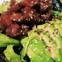 Tuna Poke Salad · Ahi tuna, cherry tomatoes, avocado, toasted sesame seeds on a bed of baby mixed green with s...