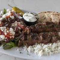 Filet Mignon Souvlaki Plate · Two skewers of our marinated filet mignon cuts, char-grilled. Served with our lemon rice, gr...