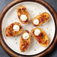 Spud Skin · Deep-fried and crispy hand-scooped potato skins. Served with sour cream.
