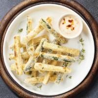 Zucchini Zone Sticks · (Vegetarian) Sliced zucchini breaded and fried until golden brown. Served with your choice o...