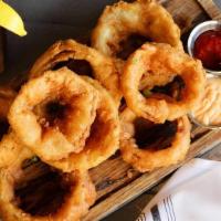 Beer Battered Onion Rings · Sweet yellow onions, farmhouse saison beer batter, house made beer salt, scallions, served w...