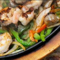 Seafood Fajita · Grilled shrimp and scallops cooked with tomatoes, onions, & bell peppers served on a hot ski...