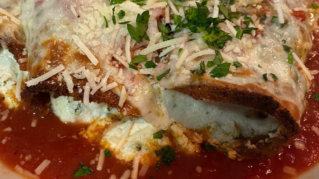 Eggplant Rollatini App · Made to order freshly breaded eggplant filled with a three cheese blend (mozzarella, parmesan & ricotta) and pesto served in red sauce with melted mozzarella on top.