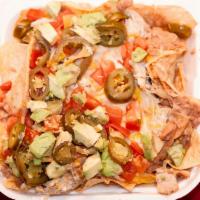 Nachos Grande · Chips topped with refried beans, jack cheese, choice of meat, tomatoes, diced avocado, jalap...
