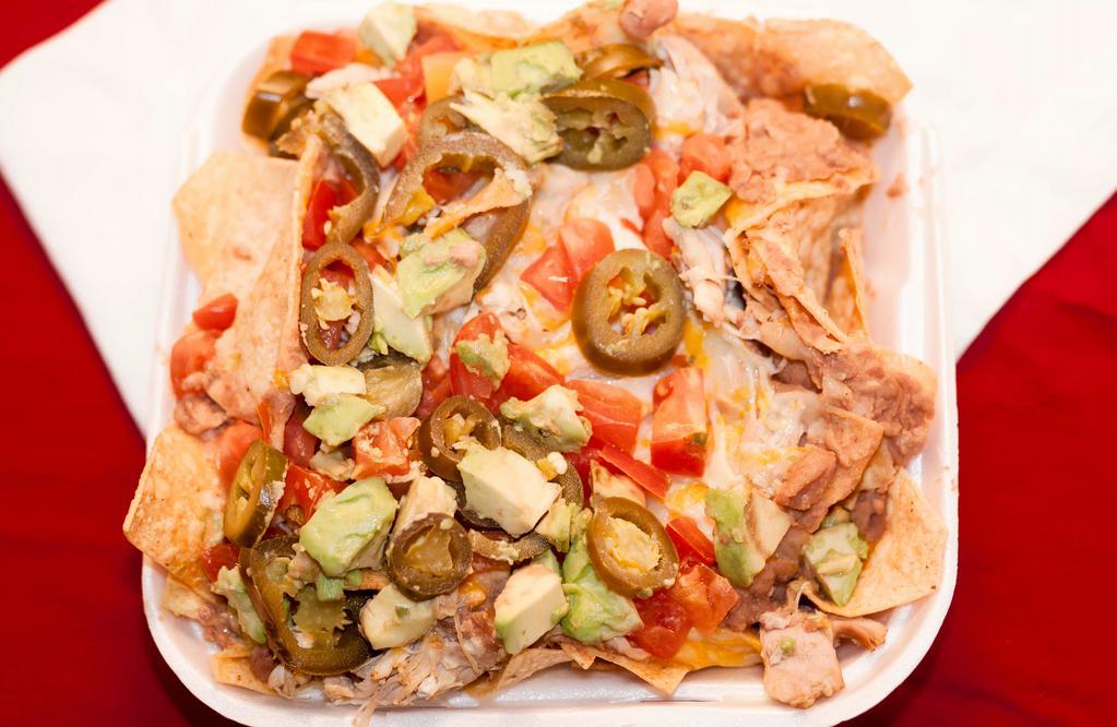 Nachos Grande · Chips topped with refried beans, jack cheese, choice of meat, tomatoes, diced avocado, jalapeños and sour cream.