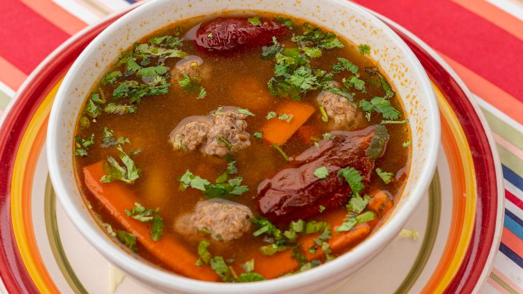 Albondigas · Meatballs in a spicy broth with Mexican spices, green onion, carrots and potatoes.