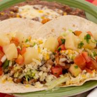 Maui Taco Dinner · Two grilled teriyaki chicken tacos on flour tortillas, topped with pineapple salsa.  Served ...