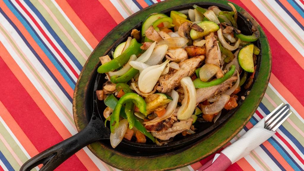 Fajitas · All fajitas seasoned and grilled with fresh onions, green bell peppers, tomatoes, mushrooms, zucchini, and spices. Served with refried beans, Mexican rice and choice of corn or flour tortillas.