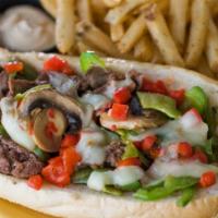 Philly Cheesesteak · Shaved sirloin, cheese sauce, sautéed onions, black pepper aioli served on a  Philly authent...