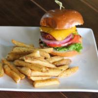 The Vegan Beyond Burger W/ Chips · Meatless vegan beyond burger topped with lettuce, tomato, red onion, and pickles, vegan beer...