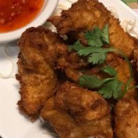 Chicken Wings · Deep fried breaded chicken wings served with sweet and sour sauce.