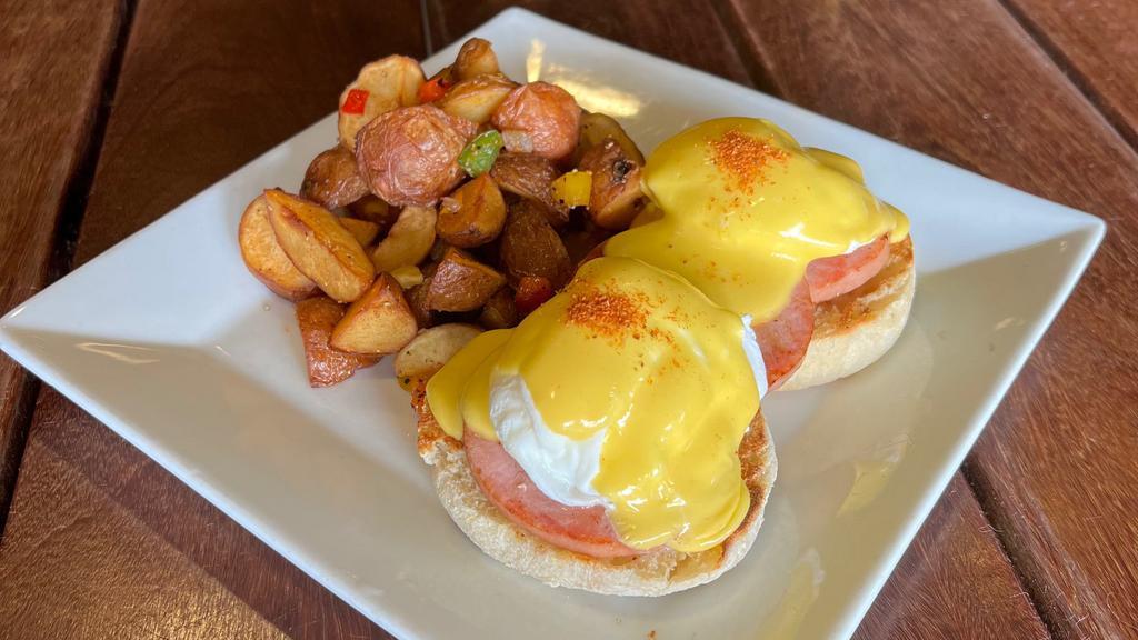 Eggs Benedict · Poached eggs, Canadian bacon, English muffin, hollandaise sauce and choice of potatoes or mixed fruit