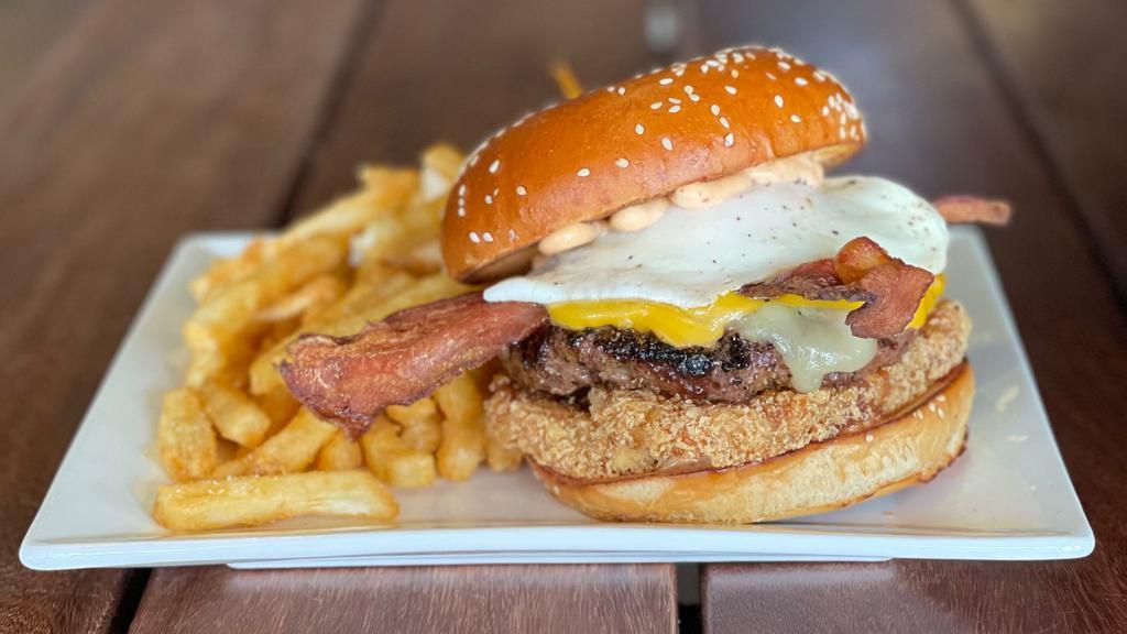 Breakfast Burger · 8oz CAB patty, American and white cheddar, bacon, fried egg, chipotle aioli, hash brown, sesame bun