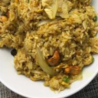 Pineapple Fried Rice · Stir-fried Jasmine rice with eggs, madras curry powder, white onions, raisins, cashew nuts a...