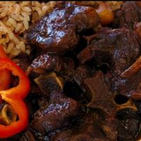 Oxtail Meal · Jamaican style oxtails with rice and peas and steamed cabbage
